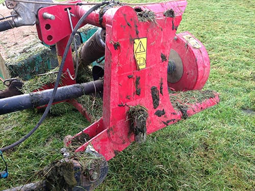 Photo of a dirty mower due to post graze topping of grass