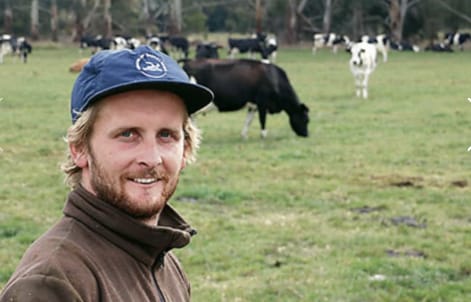 Photo of Mark Bouma on farm checking grazing residuals